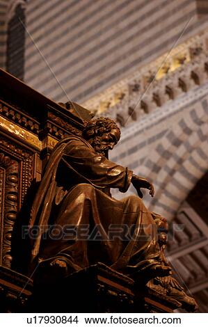 view of carved ornate wooden pulpit from below, with striped stone of interior arches in background View Large Photo Image Picture - view of carved ornate wooden pulpit from below, with striped stone of interior arches in background. Fotosearch