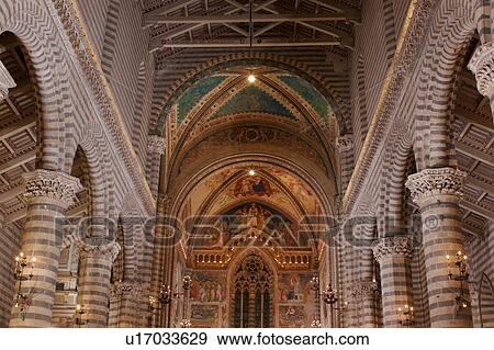 View Of Central Nave Illuminated With Striped Stone Columns Wooden Ceiling Barrel Vaulted Ceiling Window And Frescoes Of Apse Stock Photo