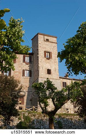 View of hilltop medieval town, showing old stone walls, tower and ring of ancient houses against summer afternoon blue sky View Large Photo Image Stock Image - View of hilltop medieval town, showing old stone walls, tower and ring of ancient houses against summer afternoon blue sky. Fotosearch