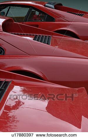 Stock Photo - View of parked red Ferraris, side and rear view, seen from above, on cloudy rainy day. Fotosearch