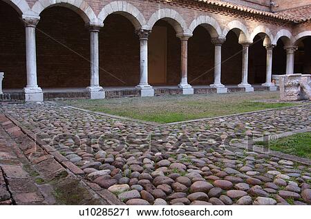 Stock Image - View of part of cloister, near Duomo, Ferrara. Fotosearch