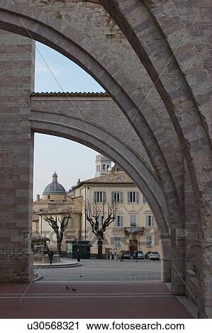 View of Piazza of Santa Chiara, Assisi, looking through lateral flying buttresses of the church View Large Photo Image Stock Image - View of Piazza of Santa Chiara, Assisi, looking through lateral flying buttresses of the church. Fotosearch