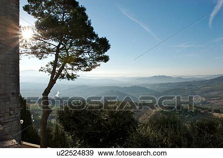 Stock Photo - view of Tiber Valley and outline of Todi, from Piazza, Montecastello di Vibio, sunrise with early morning mist. Fotosearch