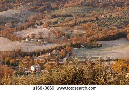 Stock Photo - View of Tiber Valley, in early morning golden winter sun, fields and farmland with light dusting of snow. Fotosearch