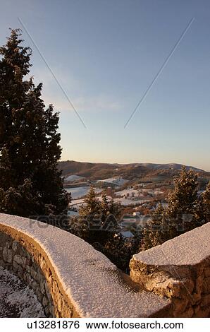View of Tiber Valley, in early morning golden winter sun, fields and farmland with light dusting of snow, snow covered stone wall in foreground and blue sky View Large Photo Image Stock Photograph - View of Tiber Valley, in early morning golden winter sun, fields and farmland with light dusting of snow, snow covered stone wall in foreground and blue sky. Fotosearch
