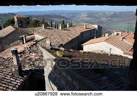 Stock Photo - view of vineyards in winter with bare vines against blue sunny sky, and white clouds. Fotosearch