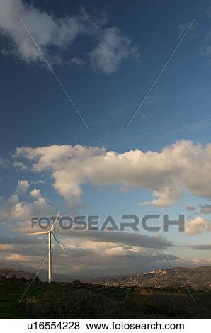 view of wind turbine, on grassy hill, in Southern Italy at sunset, against blue sky, with town on distant hillside View Large Photo Image Stock Photo - view of wind turbine, on grassy hill, in Southern Italy at sunset, against blue sky, with town on distant hillside. Fotosearch