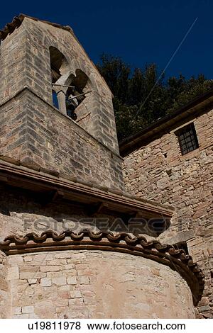 View upward of rural medieval chapel, Romanesque architecture detail of apse and bell tower, against deep blue sky View Large Photo Image Stock Photo - View upward of rural medieval chapel, Romanesque architecture detail of apse and bell tower, against deep blue sky. Fotosearch
