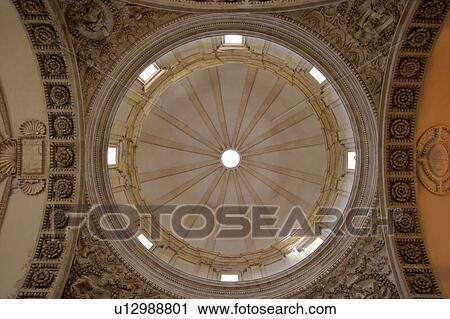 Stock Image - View upwards of central cupola, Todi Tempio di Bramante, Umbria, Italy, with stone carving and arch surround. Fotosearch