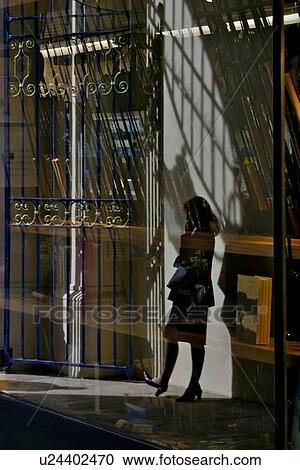 Woman standing in shadows, talking on cel phone in shopping arcade, London, UK View Large Photo Image Stock Image - Woman standing in shadows, talking on cel phone in shopping arcade, London, UK. Fotosearch