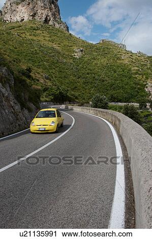 Yellow car on Amalfi Coast road View Large Photo Image Stock Image - Yellow car on Amalfi Coast road. Fotosearch