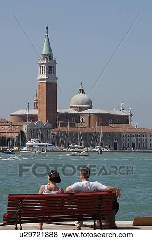 Young couple on bench viewing San Giorgio Maggiore from Riva Schiavoni View Large Photo Image Stock Photo - Young couple on bench viewing San Giorgio Maggiore from Riva Schiavoni. Fotosearch