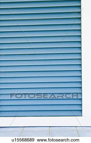 Stock Photo - Close-up of a closed shutter of a store. Fotosearch