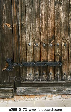 Stock Image - Close-up of a closed wooden door. Fotosearch