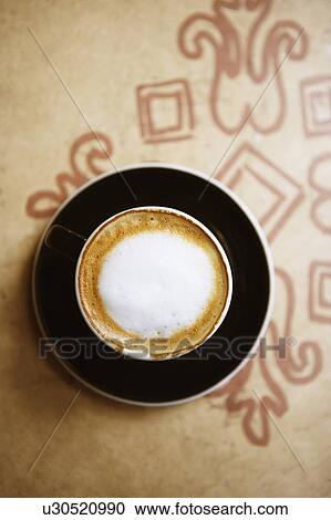 Stock Image - Close-up of a coffee cup on a saucer. Fotosearch