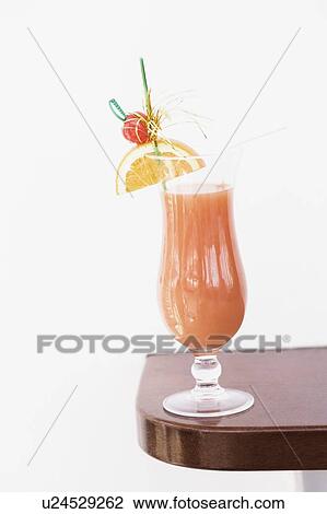 Stock Image - Close-up of a glass of cocktail on a rack. Fotosearch