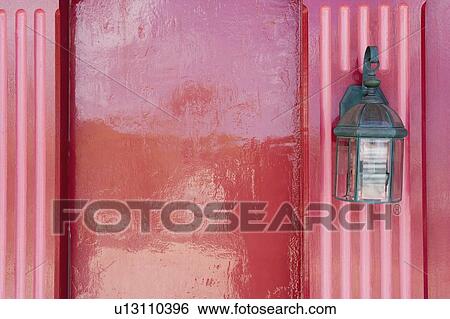 Stock Photograph - Close-up of a lantern mounted on a wall. Fotosearch