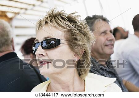 Close-up of a mature woman wearing sunglasses View Large Photo Image Stock Photo - Close-up of a mature woman wearing sunglasses. Fotosearch