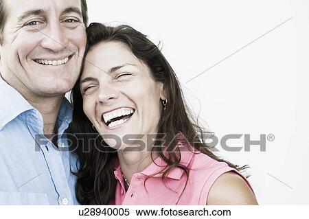 Stock Photography - Close-up of a mid adult couple smiling. Fotosearch