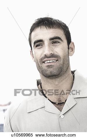 Stock Photography - Close-up of a mid adult man smiling. Fotosearch