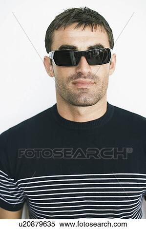 Close-up of a mid adult man wearing sunglasses View Large Photo Image Stock Photography - Close-up of a mid adult man wearing sunglasses. Fotosearch