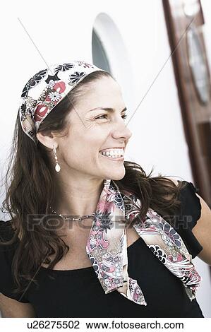 Stock Image - Close-up of a mid adult woman smiling. Fotosearch