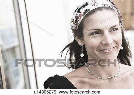 Stock Photo - Close-up of a mid adult woman smiling. Fotosearch