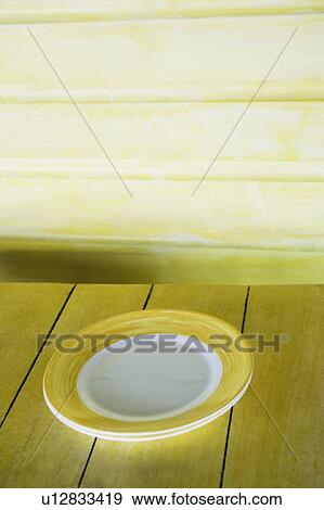 Close-up of a plate on a table View Large Photo Image Stock Photo - Close-up of a plate on a table. Fotosearch