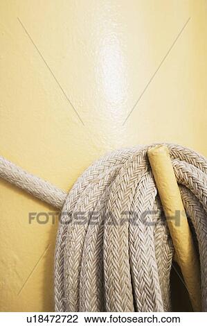 Stock Image - Close-up of a rope hanging on a handle. Fotosearch