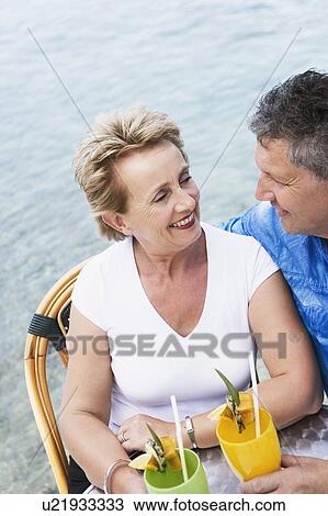 Close-up of a senior man and a mature woman looking at each other and smiling View Large Photo Image Stock Image - Close-up of a senior man and a mature woman looking at each other and smiling. Fotosearch