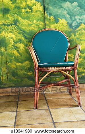 Close-up of an armchair in front of a painted door View Large Photo Image Stock Image - Close-up of an armchair in front of a painted door. Fotosearch