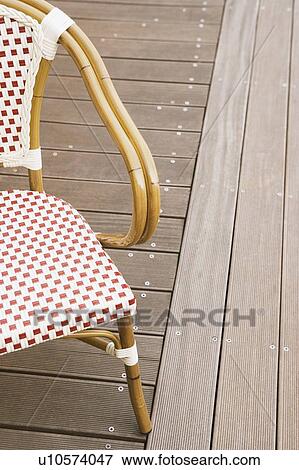 Close-up of an empty chair on a floorboard View Large Photo Image Stock Photo - Close-up of an empty chair on a floorboard. Fotosearch