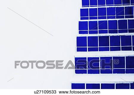 Stock Image - Close-up of blue tiles on a staircase. Fotosearch