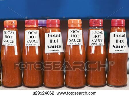 Stock Image - Close-up of bottles of sauce in a row. Fotosearch
