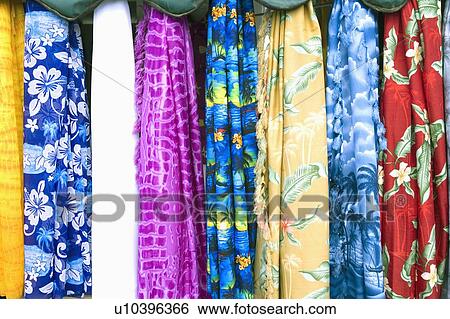Stock Photograph - Close-up of clothes hanging at a market stall. Fotosearch