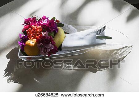 Stock Photography - Close-up of fruits and flowers in a glass tray. Fotosearch