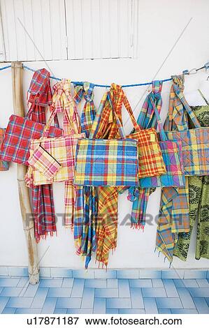 Stock Photo - Close-up of hand bags and stoles at a market stall. Fotosearch