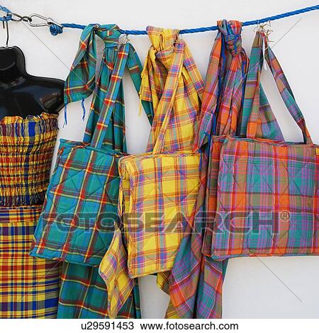 Stock Image - Close-up of hand bags hanging at a market stall. Fotosearch
