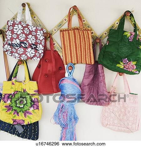 Stock Photograph - Close-up of hand bags hanging in a store. Fotosearch