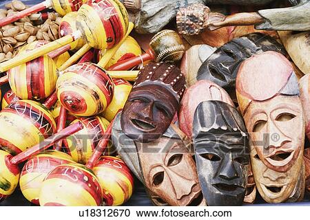 Stock Image - Close-up of masks with maracas. Fotosearch