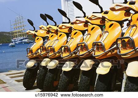 Close-up of motor scooters in a row View Large Photo Image Stock Image - Close-up of motor scooters in a row. Fotosearch