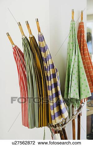 Stock Image - Close-up of multi-colored umbrellas in a store. Fotosearch