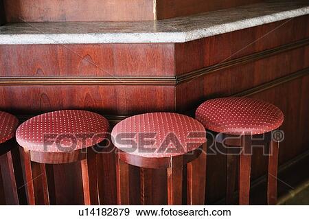 Close-up of stools in a row at a bar counter View Large Photo Image Stock Photo - Close-up of stools in a row at a bar counter. Fotosearch