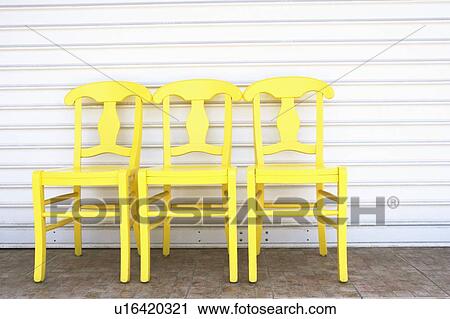 Stock Image - Close-up of three empty chairs in a row. Fotosearch