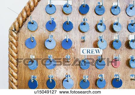 Stock Photo - Close-up of tokens hanging on a pegboard. Fotosearch