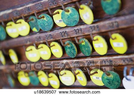 Stock Photo - Close-up of tokens hanging on a pegboard. Fotosearch