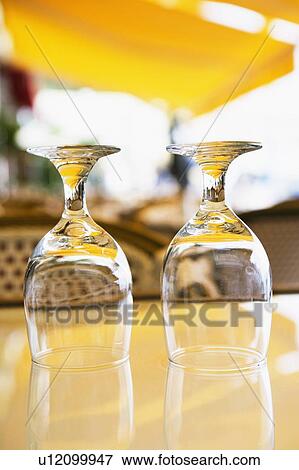 Stock Photo - Close-up of two empty wine glasses on a table. Fotosearch