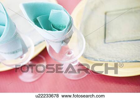 Stock Photo - Group of stem glasses and plates on a table. Fotosearch