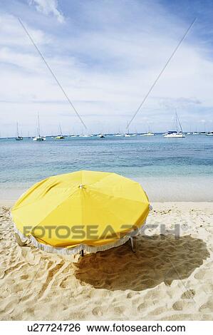 Stock Photograph - High angle view of a beach umbrella on the beach. Fotosearch