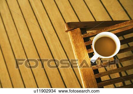 High angle view of a cup of tea on a deck chair View Large Photo Image Picture - High angle view of a cup of tea on a deck chair. Fotosearch